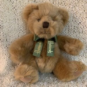 Harrods teddy bear, beige with a green bow, 10 inches tall.
